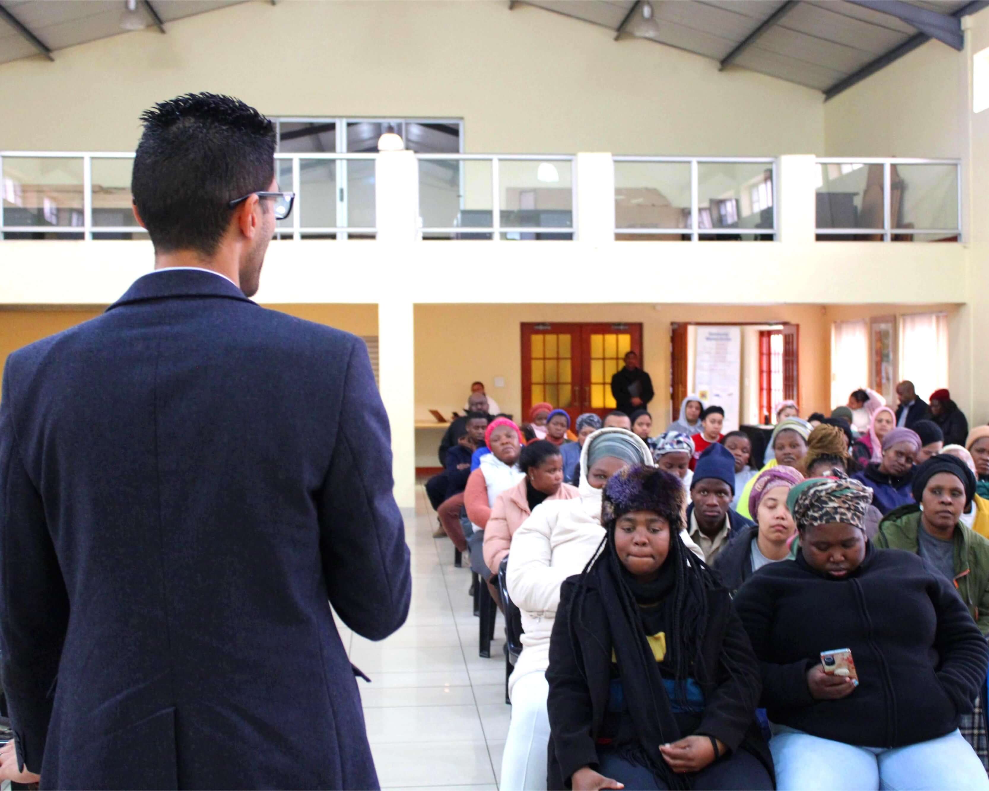 A man speaking with a group of people